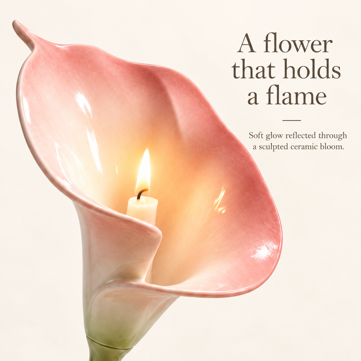 Close-up of a taper candle flame glowing inside the blush ceramic calla lily candle holder.